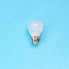 LED energy saving bulb on blue background. Square