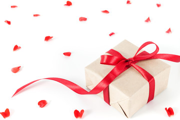 Present or gift box in a craft paper with gold ribbon bow