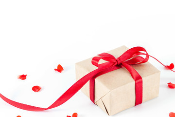 Present or gift box in a craft paper with gold ribbon bow