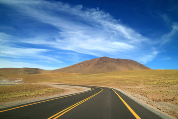 Curved Road to the Left in the Atacama Desert, the High Plateau Desert in Northern Region of Chile,...