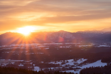 Sunrise at the Hohenpeißenberg, a mountain in Bavaria. A perfect view zo the bavarian alps with red morning glow in the sky.