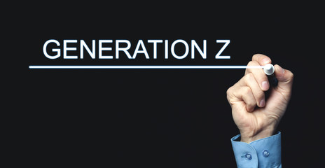 Hand with pen writing Generation Z in screen.