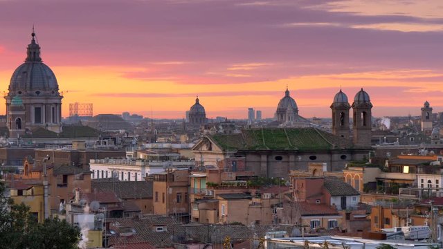 Sunrise in winter Rome, Italy. Panoramic shot of beautiful Rome from Terrazza del Pincio with red and vanila morning sky background.