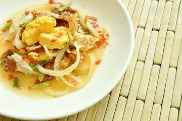 spicy fried egg cutting with onion Thai salad on plate