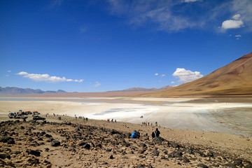 Fototapeta na wymiar Many of tourists waiting for the green water effect of Laguna Verde or the Green Lake on the lake shore, Potosi department of Bolivia