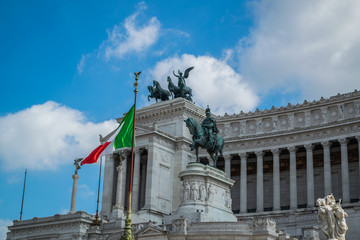 Fototapeta na wymiar Rome, Italy. Famous Vittoriano with gigantic equestrian statue of King Vittorio Emanuele II with italian flag in front of it
