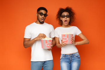 Shocked couple 3d glasses watching movie with popcorn