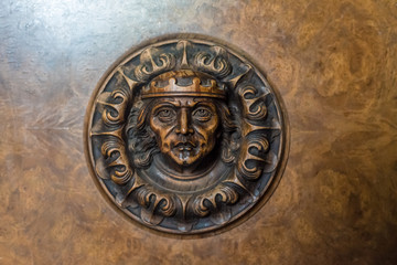 Ancient mask, relief on wood.