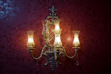 Stylish lamp on the wallpaper . Wall light of gilded metal with two electric candles . vintage wall lamp isolated on white with clipping path - Image