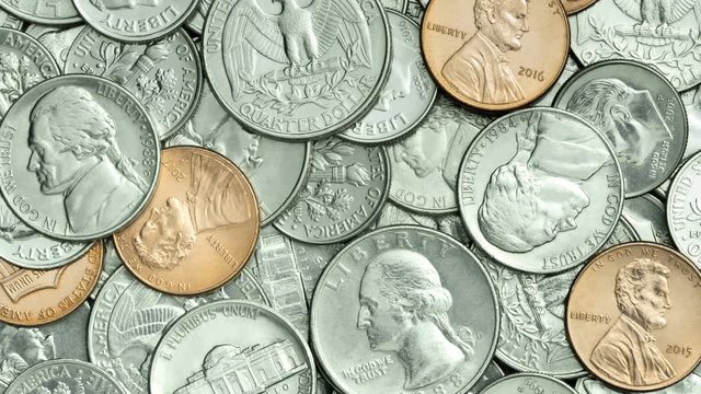 Tilt up VDO of USA coins, American coins for business, money, financial and economy concept. Video 4K Pile of Golden, silver, copper, quarters, nickels, dimes, cent and dollar coins for background.