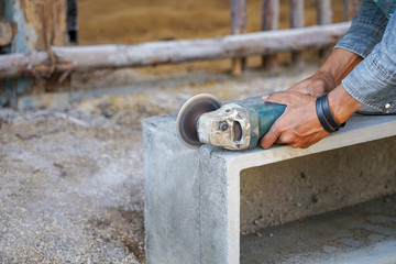 Worker used grinder cut concrete black.
