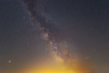 beautiful dramatic night sky with milky way and shining near a horizon