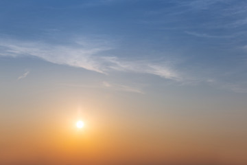 beautiful sunset scene, evening low sun on the cloudy sky