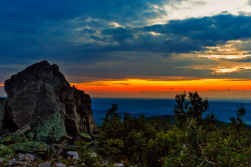Fototapeta premium sunset in the clouds above the distant hills