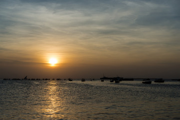Fototapeta na wymiar Silhouette of a traditional Dhow sailing boats,beautiful sunset, Stone Town, Zanzibar, Tanzania.