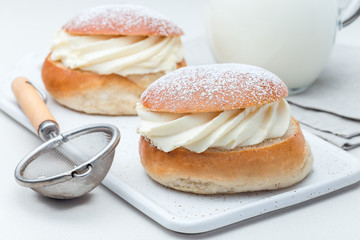Traditional swedish dessert Semla, also called Shrove bun, with almond paste and whipped cream...
