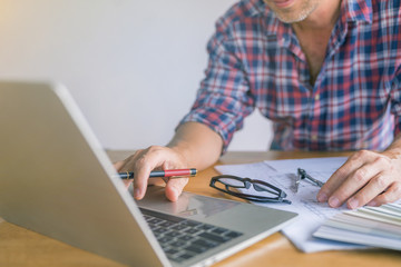 Fototapeta premium architect or civil engineer during drawing home or building in office on working table with office stationary , laptop ,color pallette sampling.
