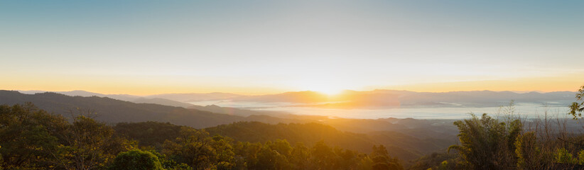 The view of the sunrise on the mountain in cold weather with fog in the mountains