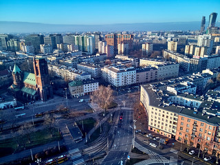 WARSAW, POLAND - NOVEMBER 27, 2018: Beautiful panoramic aerial drone view to the center of Warsaw City and Roman Catholic Parish of St. James the Apostle at Narutowicza Square, Ochota district - obrazy, fototapety, plakaty