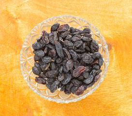 Raisins in a glass cup on the table