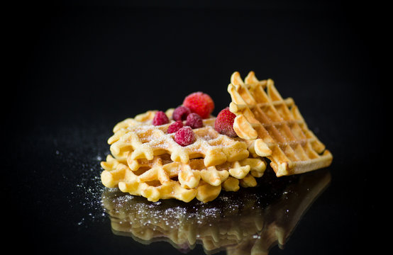 cooked sweet Viennese waffles on a black