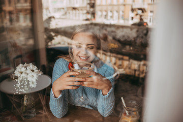 Blonde girl drink coffee and eating pancakes