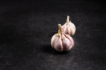 Fragrant garlic on a dark background with space for text.