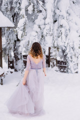 Fototapeta na wymiar winter wedding, the bride in a lilac dress