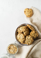 Homemade oat cookies in bowl on white background