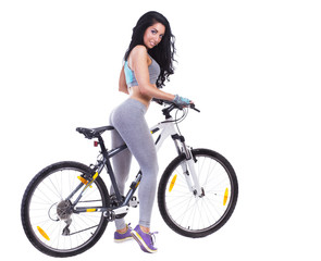 Fototapeta na wymiar Woman on a bicycle dressed in a sports uniform in gray in the studio on a white background
