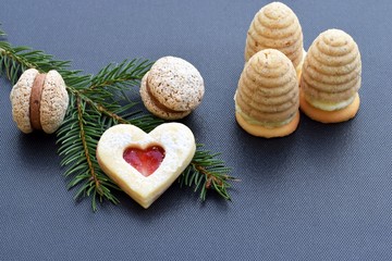Fototapeta na wymiar We love christmas cookies - coffee macaroons filled with chocolate cream and wasp nests cookies
