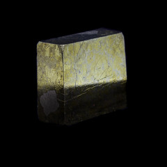 Cube of natural polished pyrite on a black background