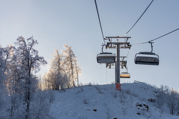 Fototapeta premium Winter in the mountains. Ski resort. Chair lift. White trees. Snow trees.