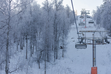Winter in the mountains. Ski resort. Chair lift. White trees. Snow trees.