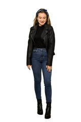 A full-length shot of a Teenager girl with leather jacket happy and smiling on isolated white background