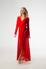 beautiful young girl in red dress on white background