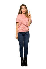 A full-length shot of a Teenager girl with pink sweater thinking an idea while scratching head on isolated white background