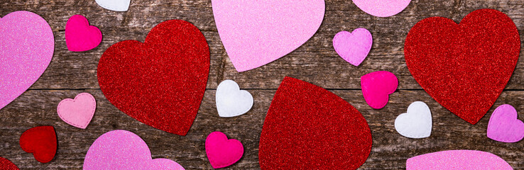 Valentines Day Background. Valentines Day Fabric Hearts Shaped on Wooden Background. Selective focus.