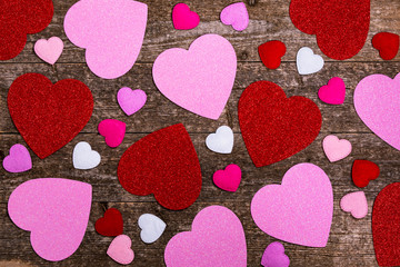 Valentines Day Background. Valentines Day Fabric Hearts Shaped on Wooden Background. Selective focus.