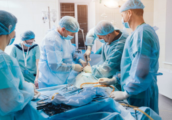 Process of gynecological surgery operation using laparoscopic equipment. Group of surgeons in...