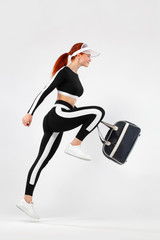 Black friday for fitness sale. Sporty fit woman with bag go to training, running on white...