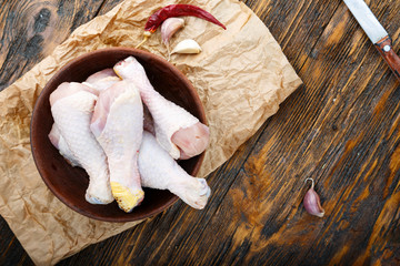 chicken legs on wooden background