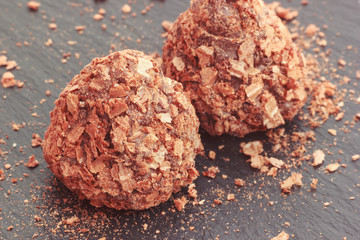 Truffle chocolate pralines candy coated with cracked waffle crumbs, selective focus