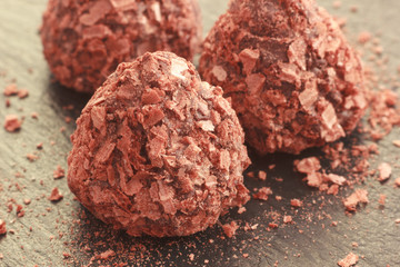 Truffle chocolate pralines candy coated with cracked waffle crumbs, selective focus