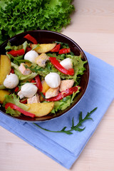 Salad with chicken, roasted potato, mozzarella cheese and red pepper in a bowl