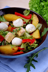 Salad with chicken, roasted potato, mozzarella cheese and red pepper in a bowl
