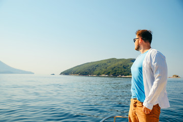 Fototapeta premium man portrait with sea and land on background