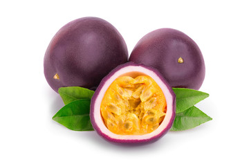 Two whole passion fruits and a half with leaves isolated on white background. Isolated maracuya