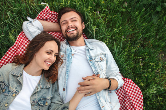 Laughing Happy Couple Lying On Meadow