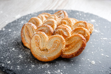 Puff pastry eyelet on slate Board, sprinkled with powdered sugar or flour.